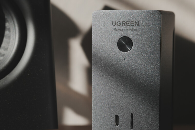 Ugreen Nexode Mini power adapter with USB-C port, casting sharp shadow in natural light.