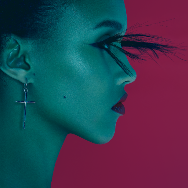 Profile of a person with dramatic split-tone lighting in teal and magenta with feathered eyelashes.