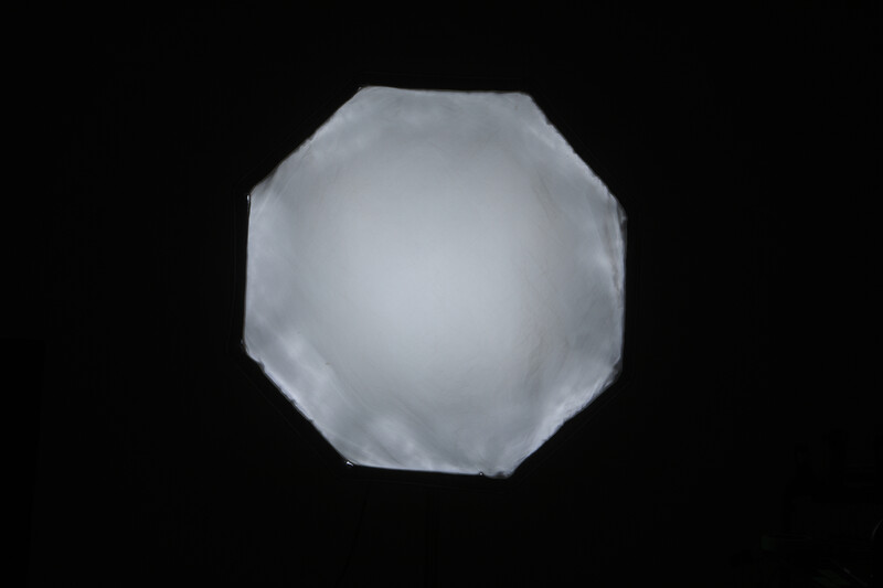 3D rendered translucent glass sphere with faceted octagonal geometry against black background.
