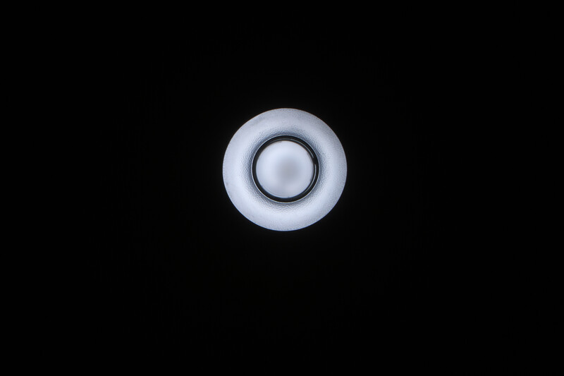 Concentric circles with soft blue gradient lighting against a black background.