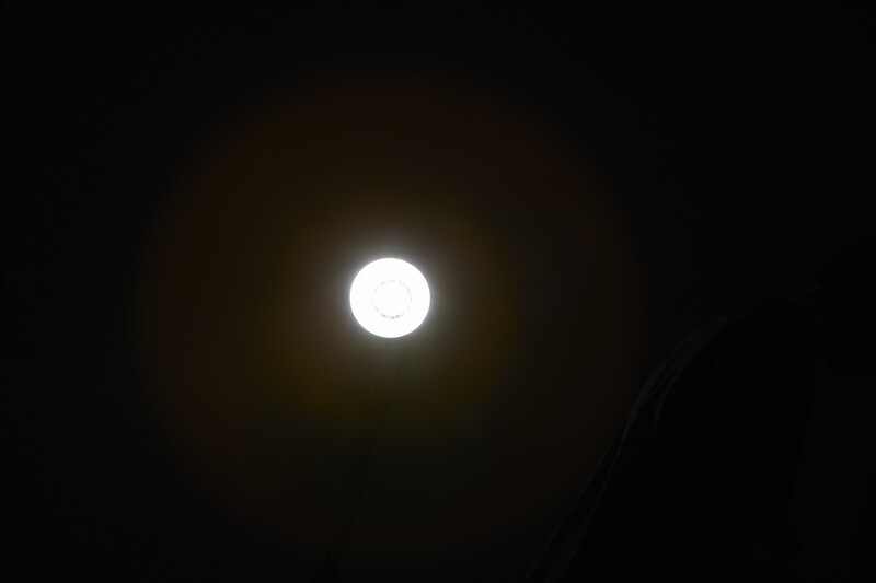 Bright full moon centered against dark night sky with subtle atmospheric glow