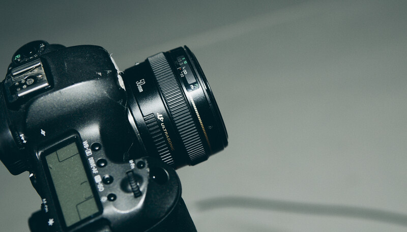 Professional DSLR camera with wide-angle lens mounted, positioned against neutral background.