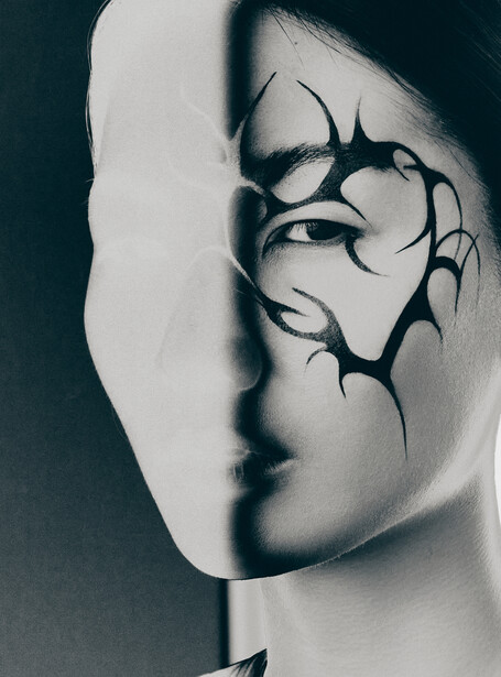 Split-face portrait with tribal line art overlaid on one half against dark background.