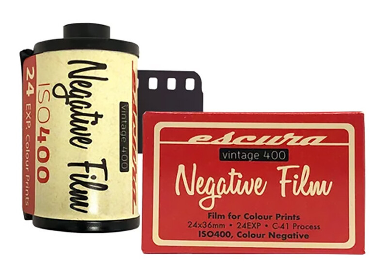 Vintage Fujichrome and Agfachrome color negative film rolls displayed with packaging.