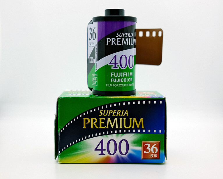 Fujifilm Superia Premium 400 film stock displayed with its box and canister against a white background.