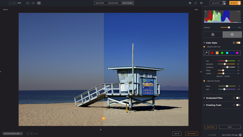 Lifeguard tower on sandy beach at dusk with calm ocean and clear blue sky.