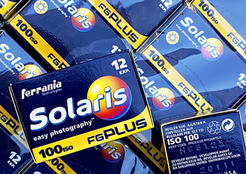 Multiple boxes of Ferrania Solaris 100 ISO color slide film with yellow and blue packaging.