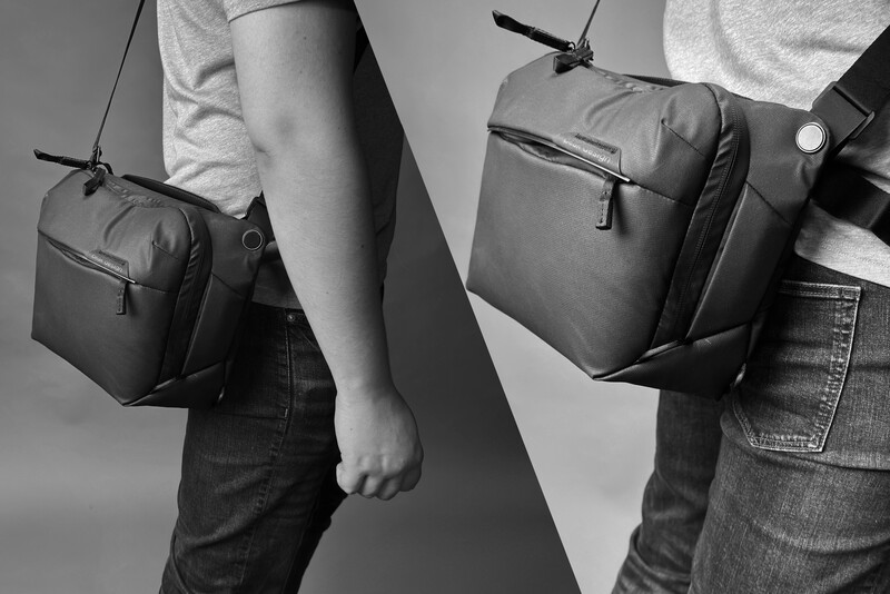 Two people wearing casual clothing and dark shoulder bags with carrying straps, photographed in black and white.