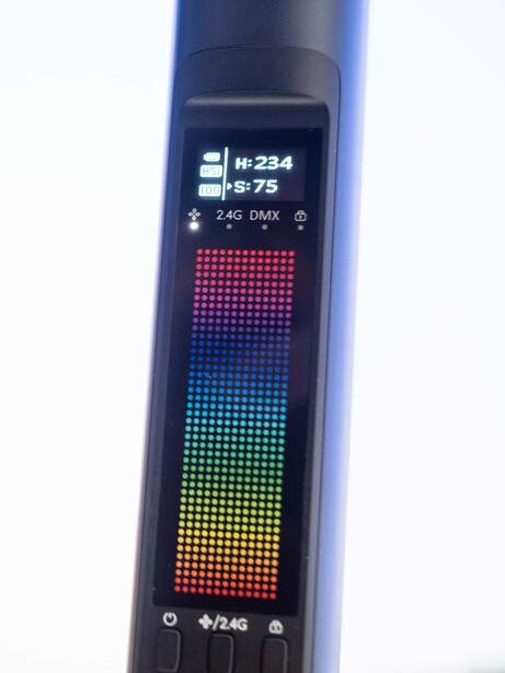 LED light meter displaying a full-spectrum color gradient from red to green on its digital display panel.