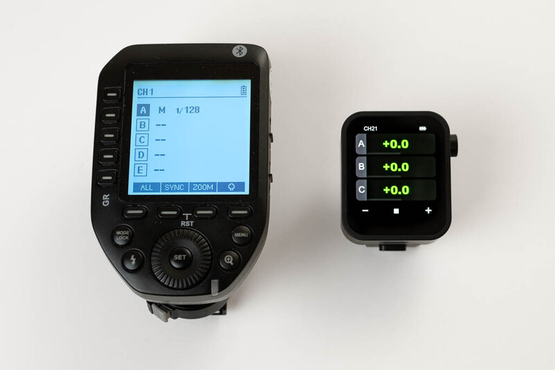Two wireless flash trigger devices displayed side by side against a white background.