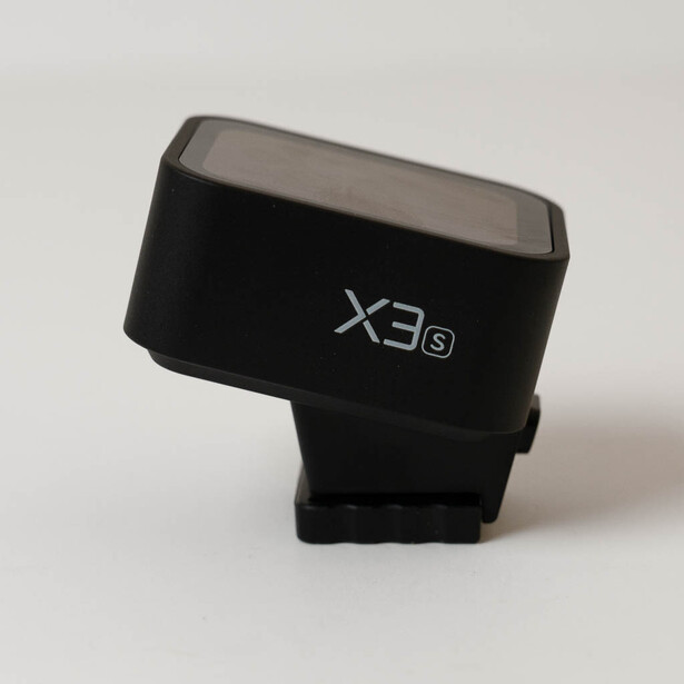 X3S camera flash unit with translucent top panel on white background.