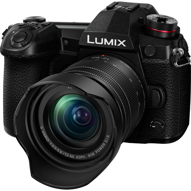 Panasonic Lumix mirrorless camera with standard zoom lens attached, shown against white background.
