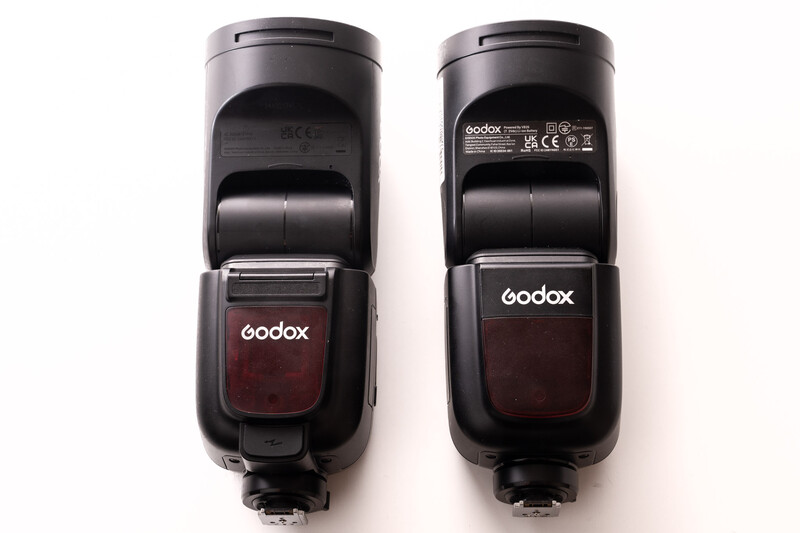 Front and back view of two Godox camera flash units side by side against white background.