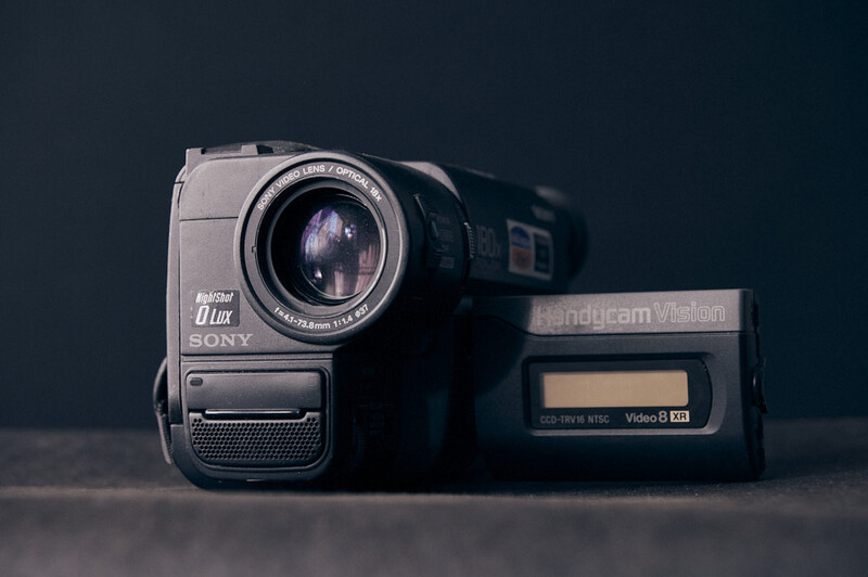 Vintage Sony Handycam video camera from the 1980s-90s era, shown from the side against a dark background.