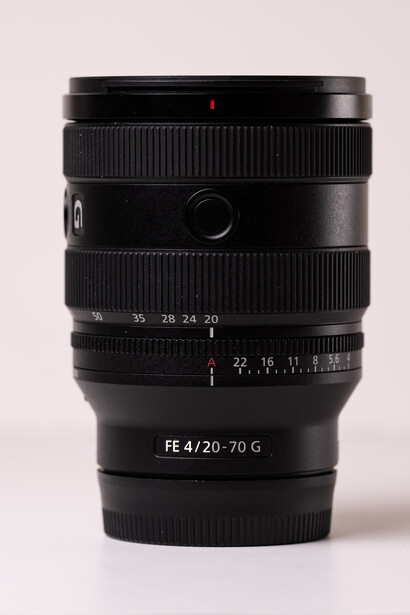 Sony FE 4/30-70 G lens with focus ring and aperture markings visible against neutral background.