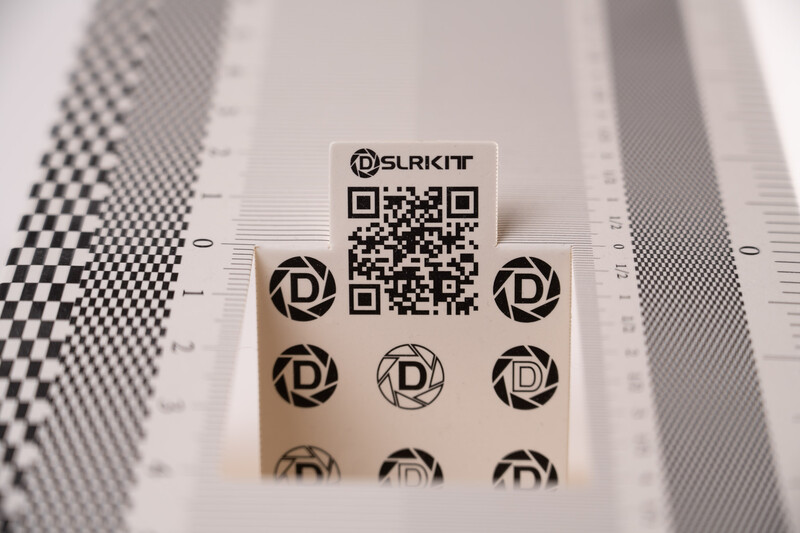 Color reference card with QR code and circular pattern targets on checkered background.