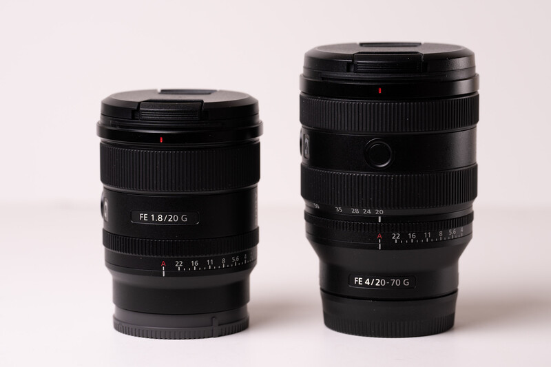 Two black Sony E-mount zoom lenses displayed side by side against a light background.