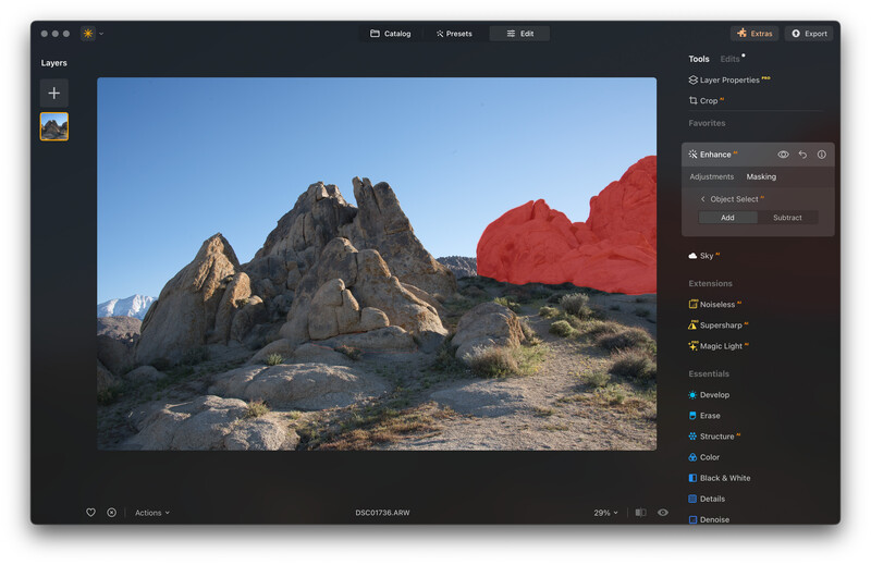 Screenshot of photo editing software showing a desert landscape with red shape overlay on rocky formations.