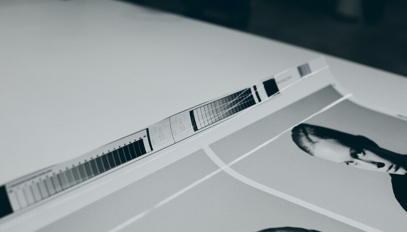 Printed contact sheets and color reference strips arranged on a white surface.