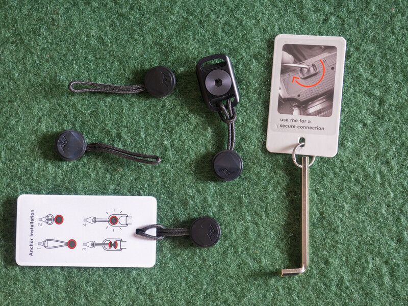 Lavalier microphone components laid out on green surface with instruction cards.