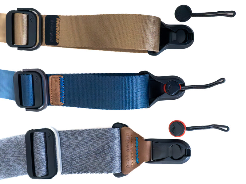 Three camera neck straps in tan, blue, and gray with black hardware and brown accents.