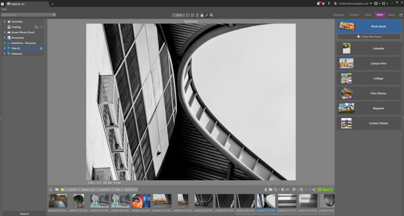 Black and white architectural photograph of curved building facades with dramatic angular lines and geometric shapes.