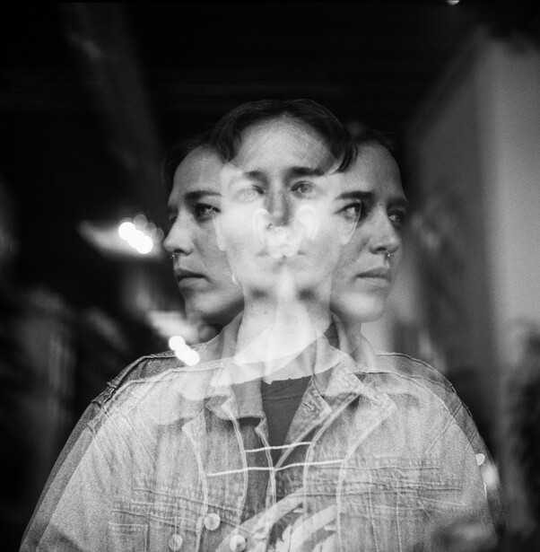 Black and white double exposure portrait blending three profile views of a man's face.