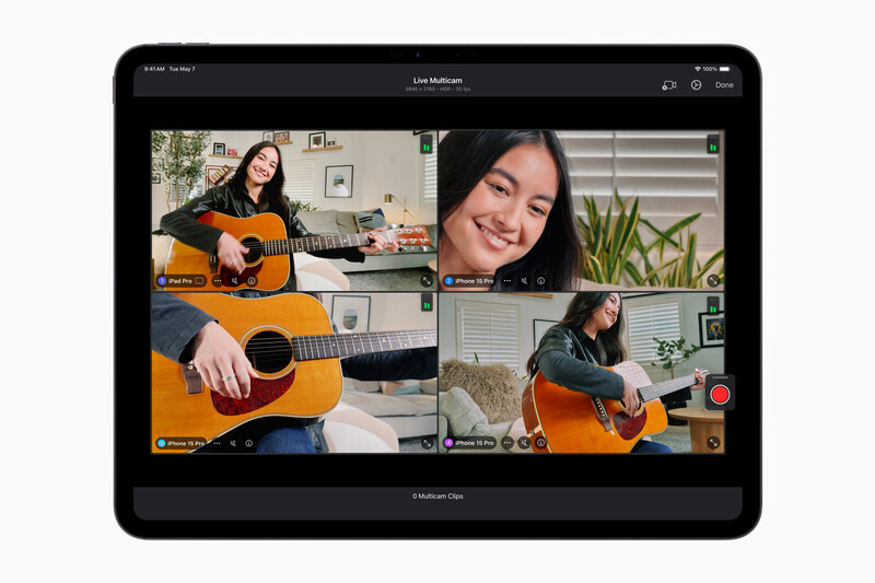 Screenshot of a video call showing four participants holding acoustic guitars in their home spaces.