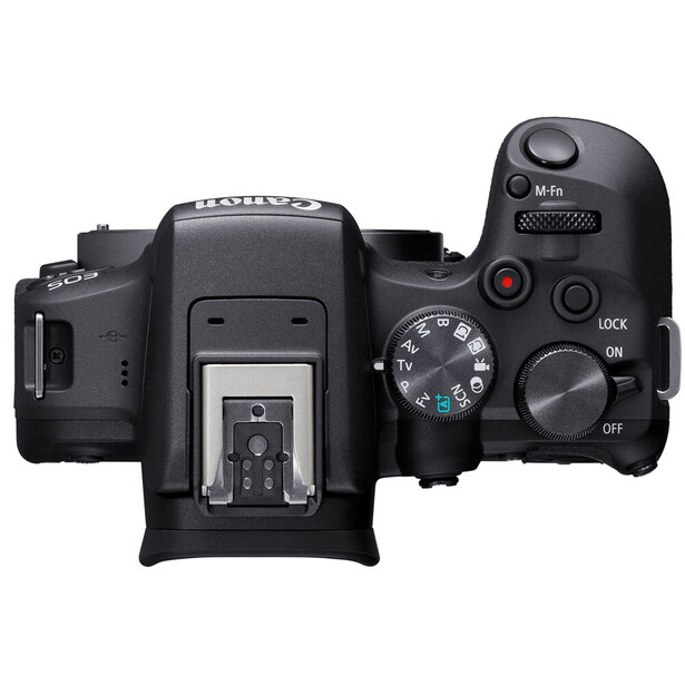 Top-down view of a mirrorless camera body showing the mode dial, hot shoe, and control buttons.
