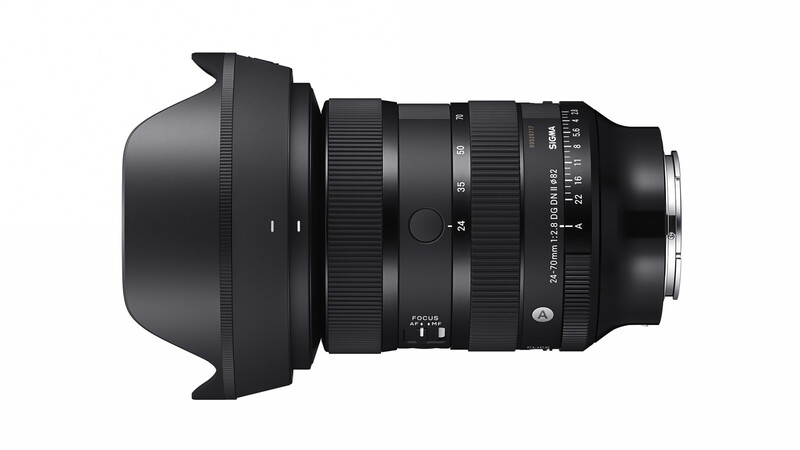 Wide-angle zoom lens with attached lens hood, shown in profile against white background.