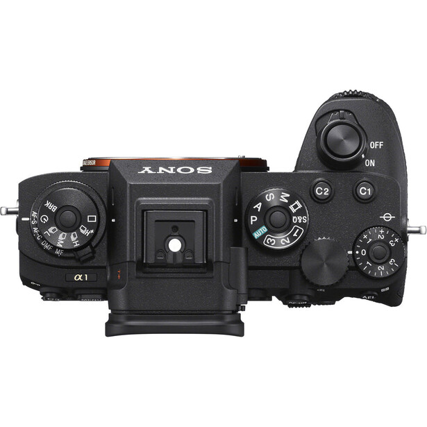 Top-down view of Sony Alpha mirrorless camera body showing dual control dials, mode buttons, and articulating rear screen.