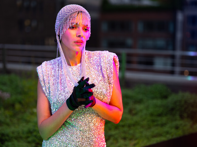 Model in silver dress on a rooftop