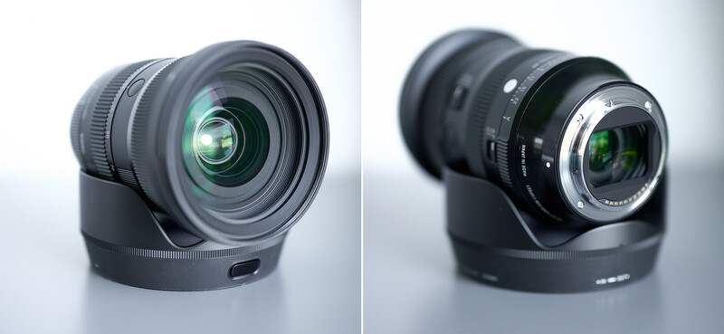Two camera lenses shown side by side with lens hoods, displaying front and rear optical elements against a neutral background.