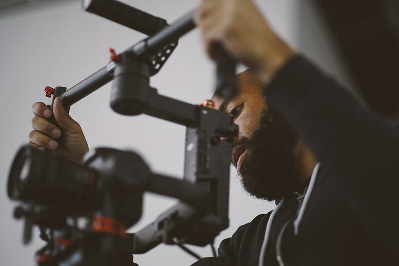 Cinematographer operating a professional cinema camera rig with follow focus system.