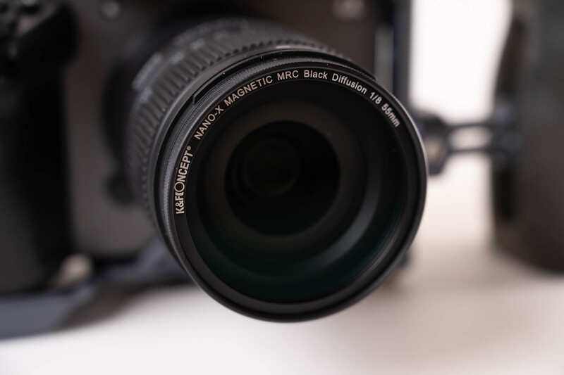 Close-up view of a camera lens with visible text markings on the barrel.