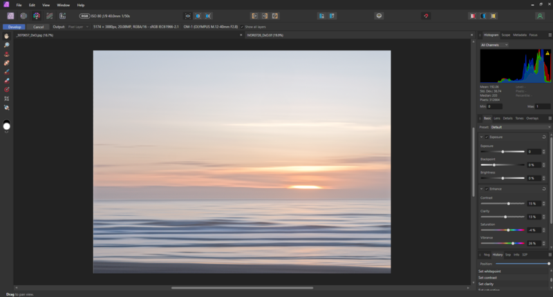 Serene ocean sunset with golden and pink hues reflecting on wet sand and calm waves.