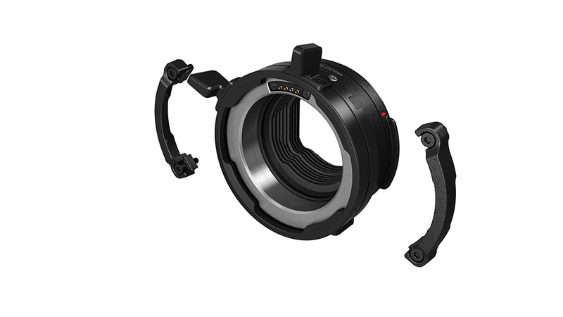 Mirrorless camera lens mount adapter with articulating handles extended on both sides.