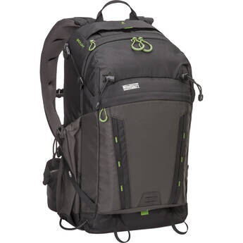Black and gray camera backpack with lime green accents and multiple compartments.