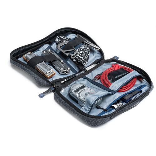 Open camera gear organizer case displaying neatly arranged photography equipment and cables.