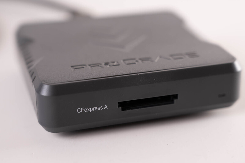 Compact black card reader device with CFexpress A slot, photographed against a light background.