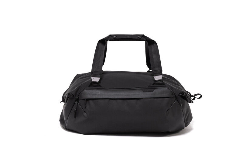 Black padded duffel bag with dual handles and front zippered pockets, photographed against a white background.