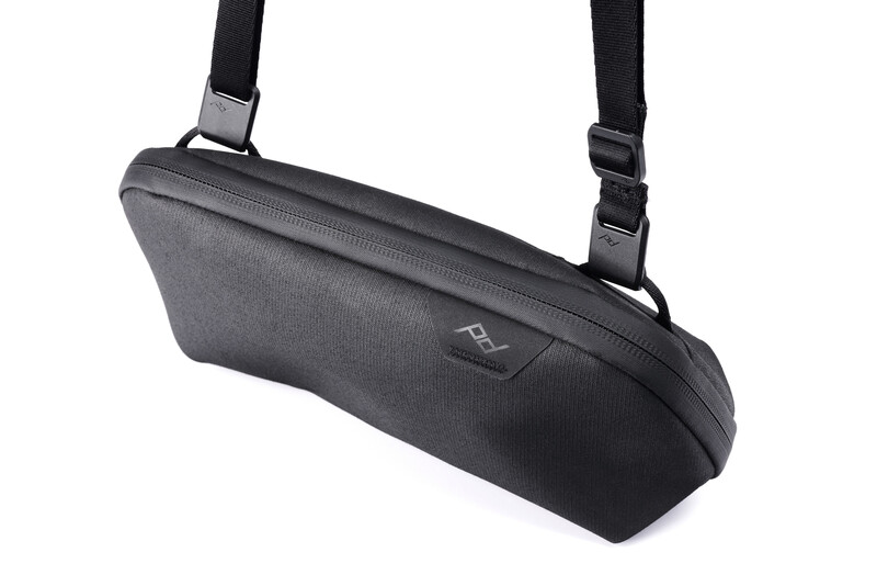 Black shoulder bag with padded construction and dual carrying straps against white background.