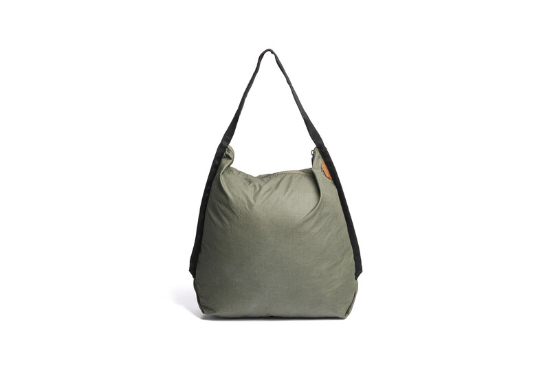 Olive green nylon hobo bag with black shoulder straps displayed against white background.