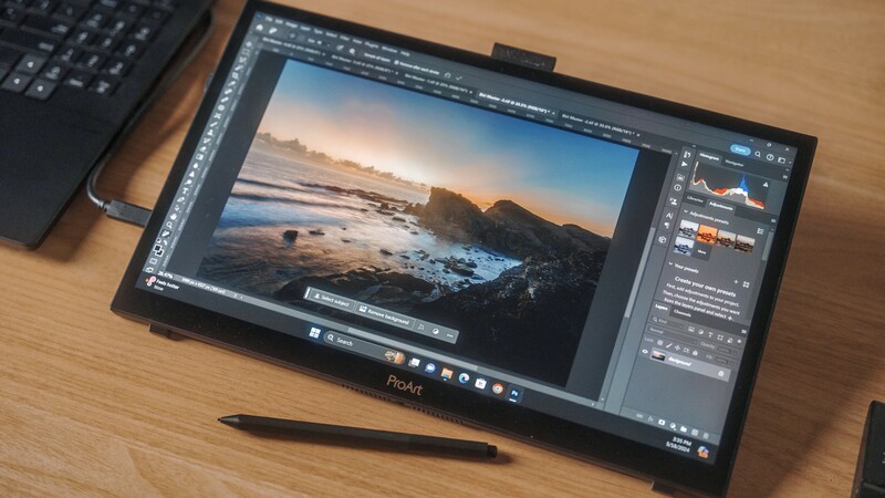 Screenshot of photo editing software displaying a coastal landscape with rocky shoreline and sunset sky.