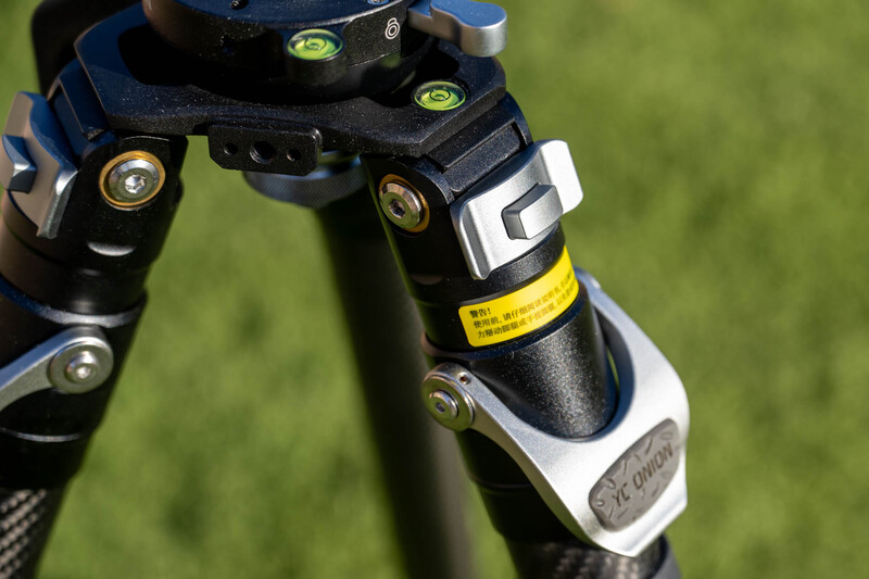 Close-up of a bicycle stem and handlebar junction with spirit levels and adjustment hardware visible.