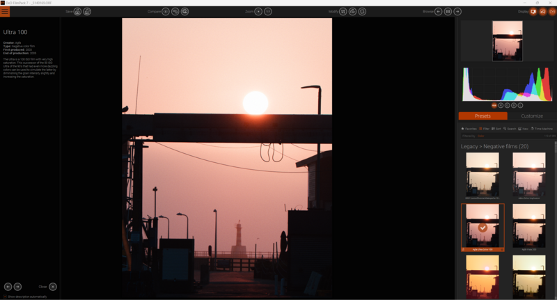 Screenshot of photo editing software showing sunset silhouette with industrial structures and power lines.