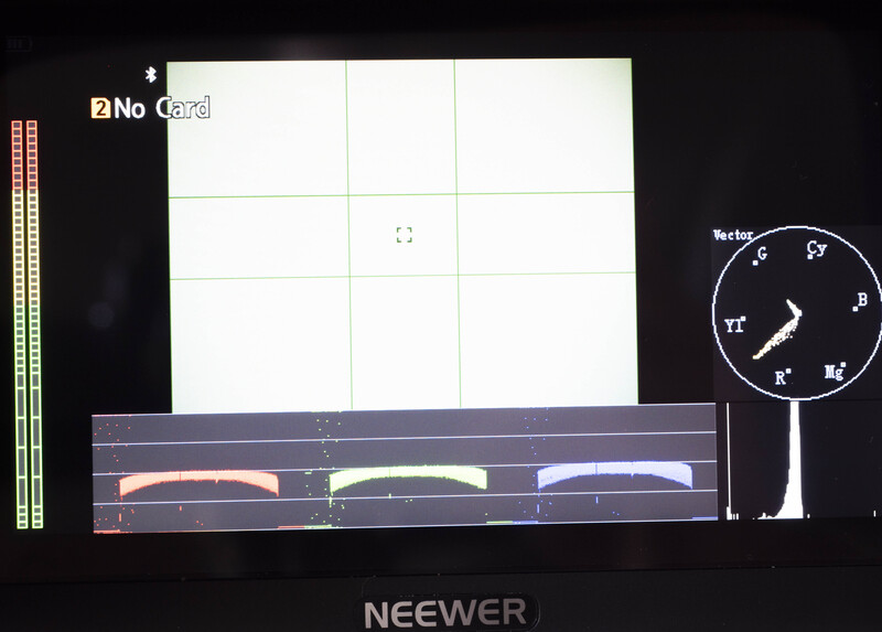 Screenshot of camera calibration software showing test chart with color reference bars and compass overlay.