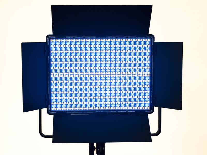 Professional LED panel light with adjustable barn doors and blue-white illuminated grid pattern.