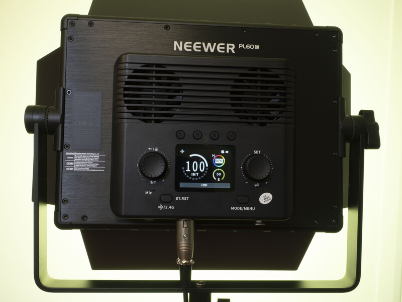 Neewer PL60B LED panel light mounted on stand, showing back control panel with dimmer, color temperature adjustment, and display screen.