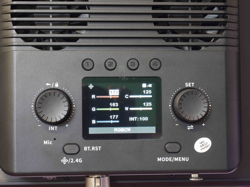 Close-up view of camera flash unit controls and display panel showing power settings and wireless sync information.